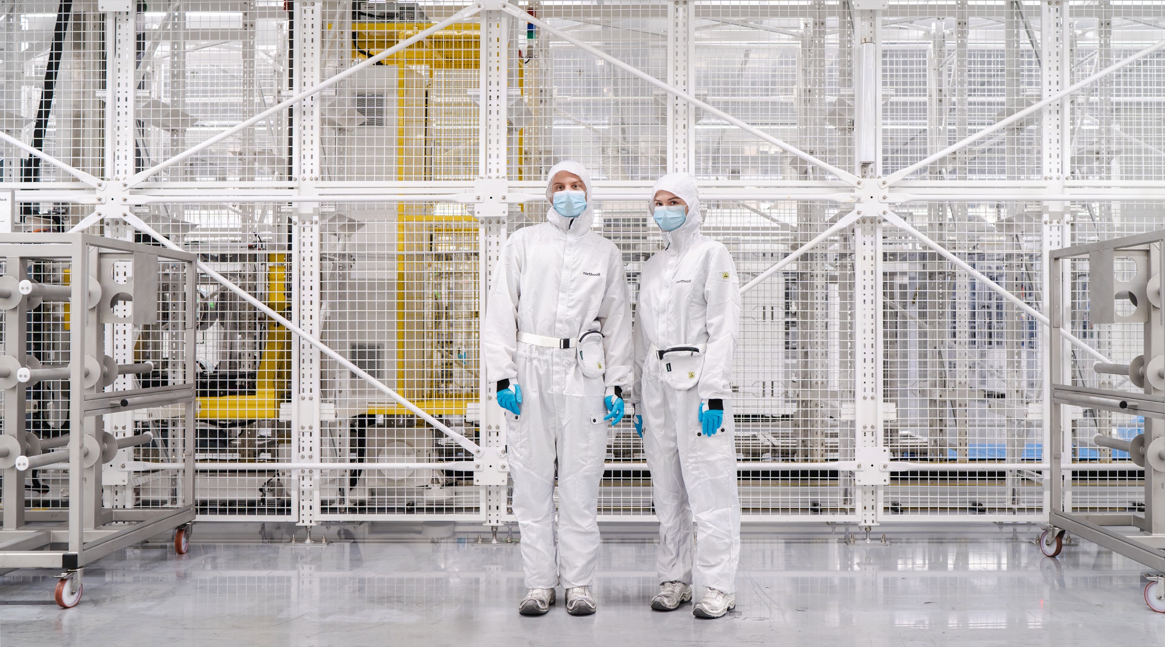 Two people in cleanroom suits at the Northvolt factory