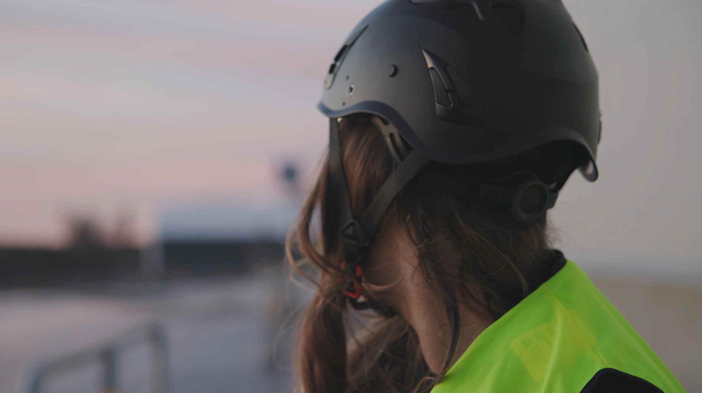 Northvolt worker in helmet at dusk